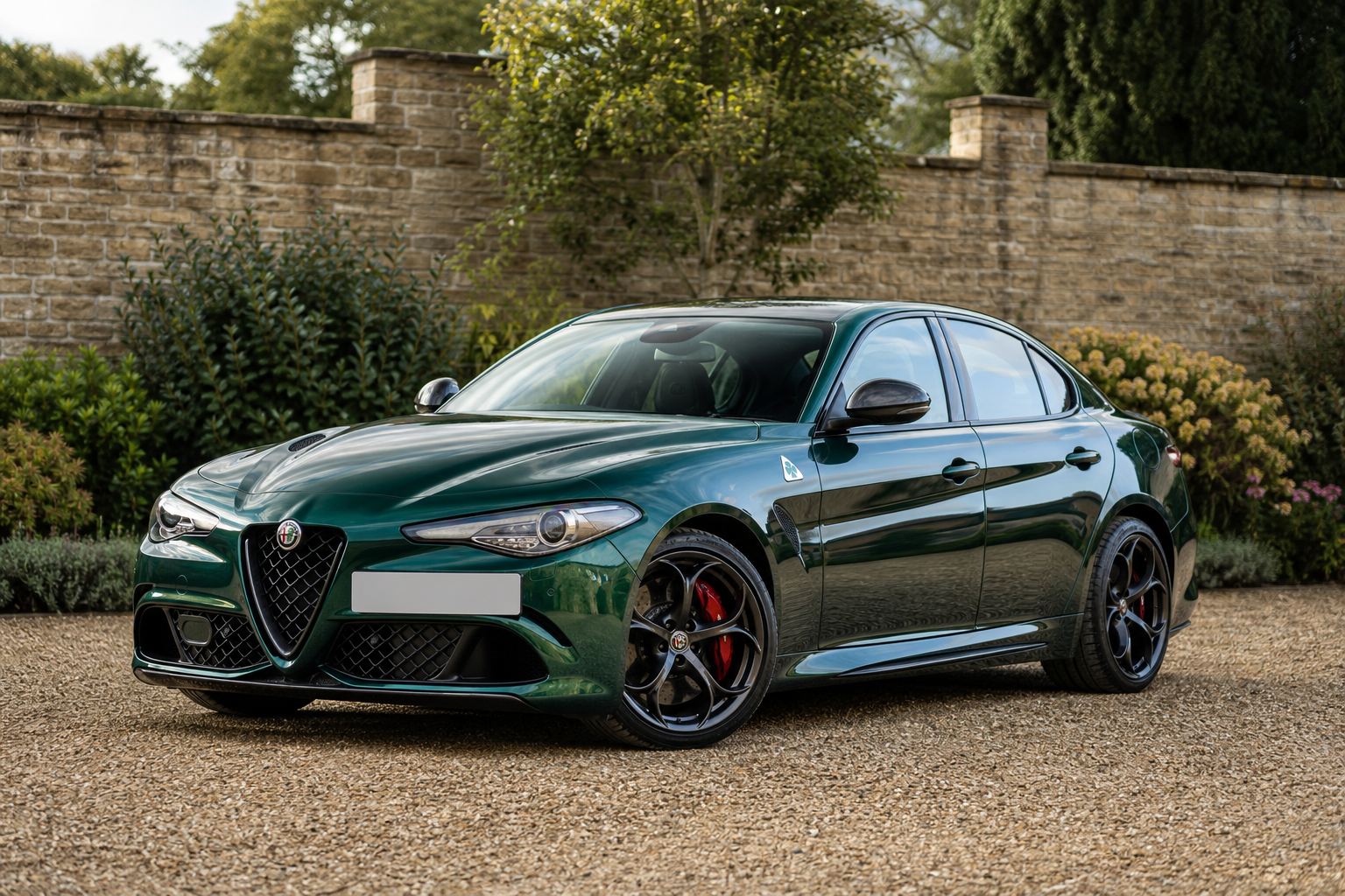 Montreal Green Alfa Romeo Giulia Quadrifoglio in a stone courtyard